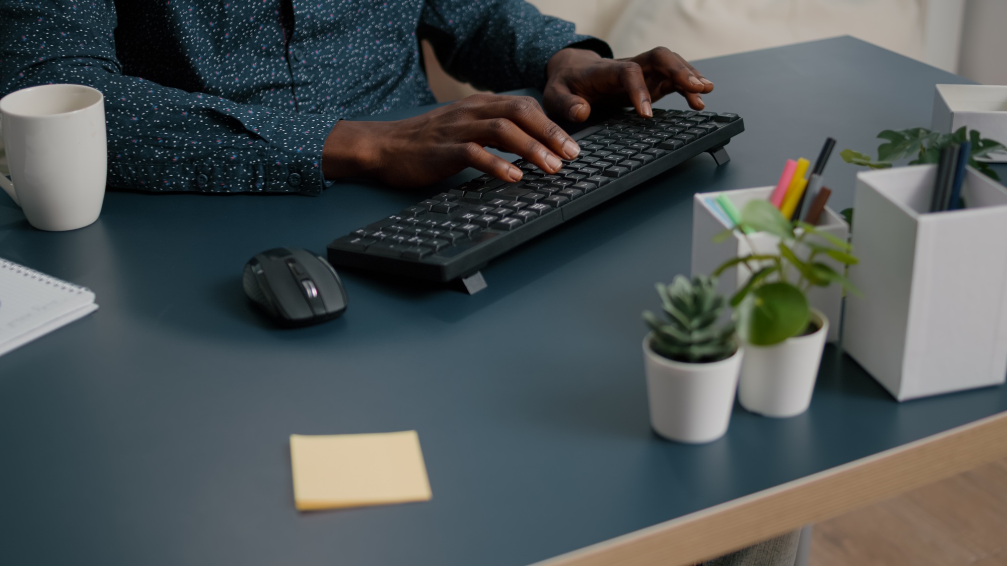 Top view of black man african american hands typing on computer keybord