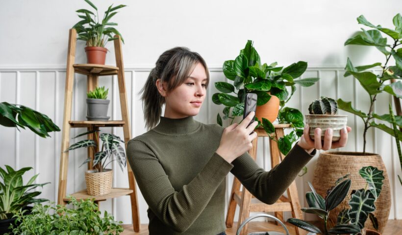 Woman taking a snapshot of her plant for social media
