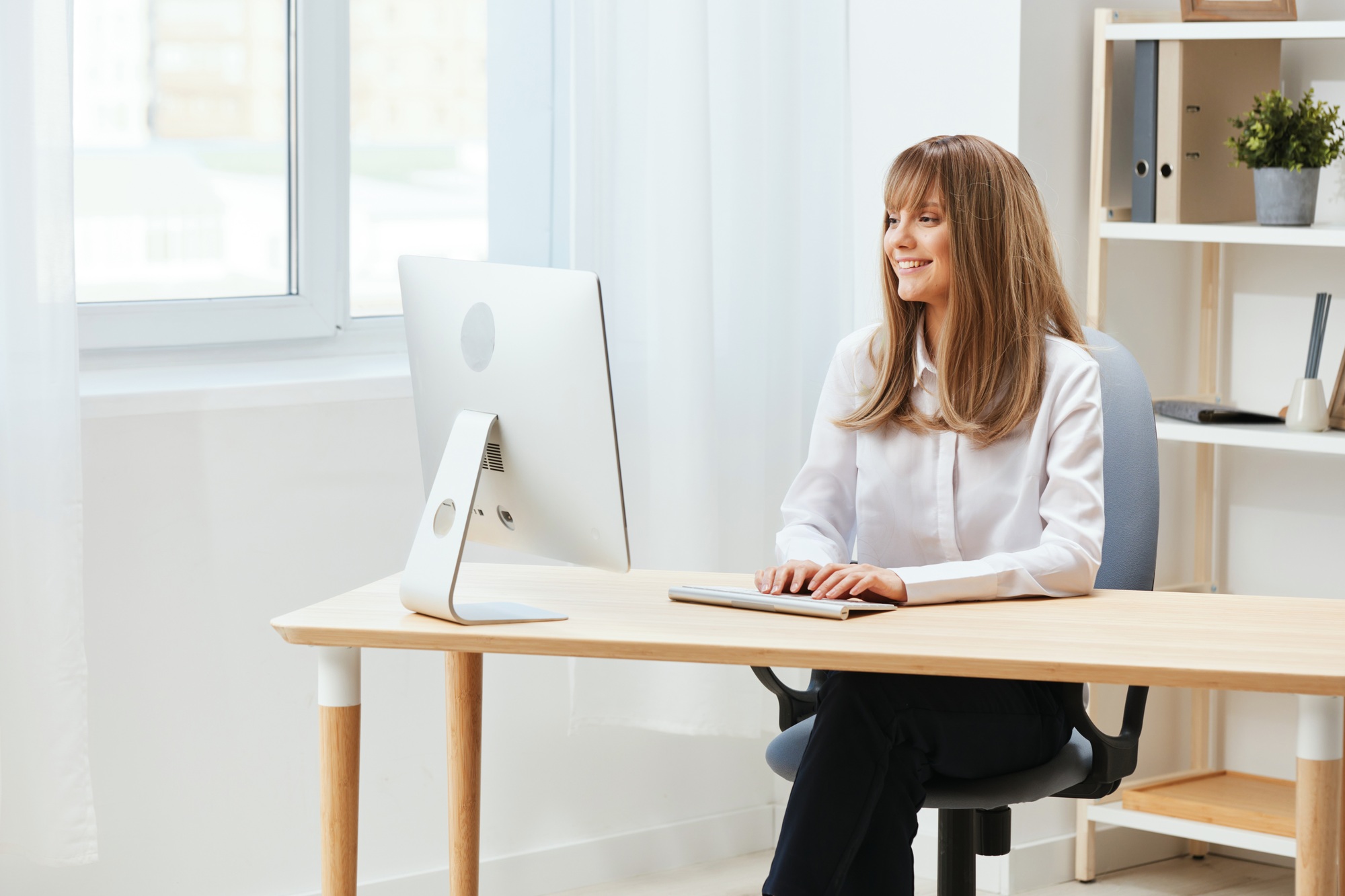 Cheerful happy adorable blonde businesswoman worker freelancer look at screen work on desktop