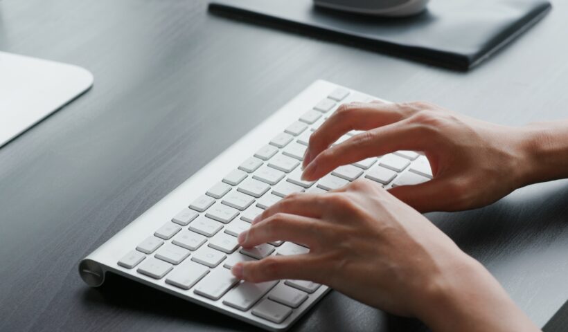 Woman type on keyboard at home